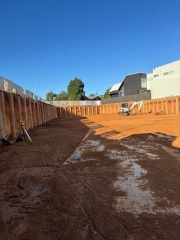A large pile of dirt is sitting in front of a house.