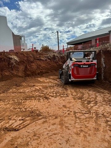 An bobcat moving earth.