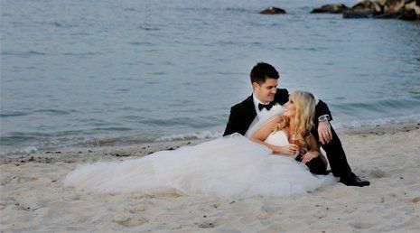 Couple lying on beach after their wedding