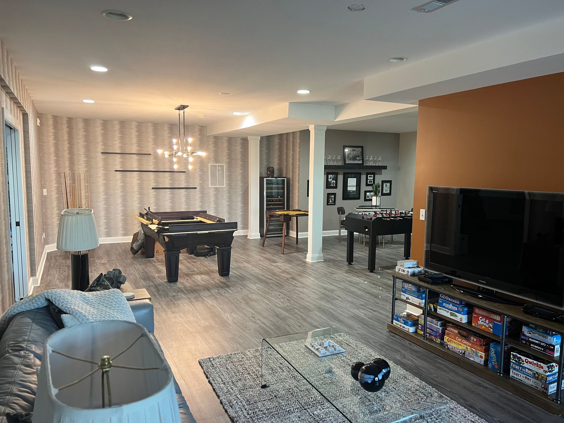 Finished basement with pool table, foosball, and TV entertainment area.