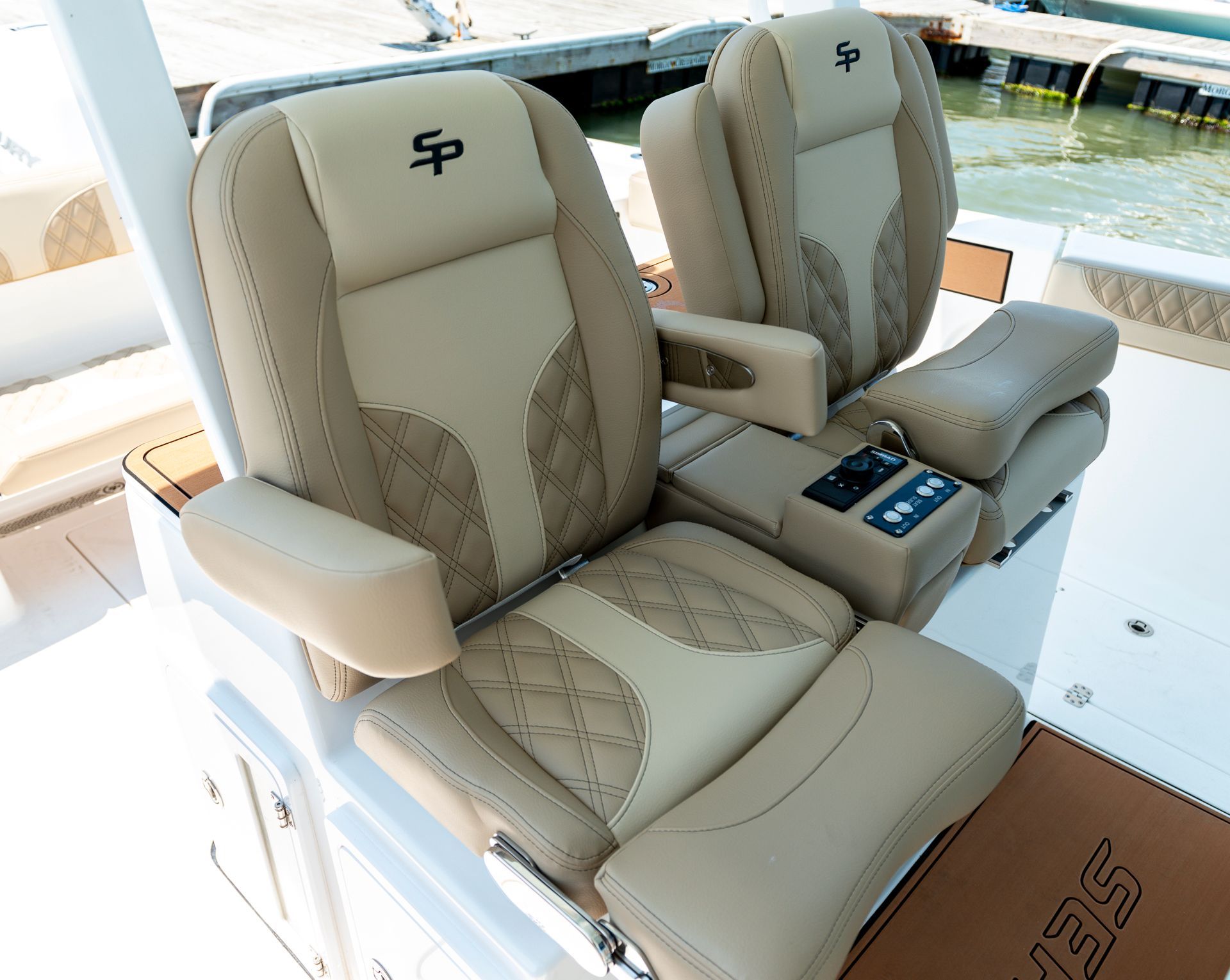 Two seats on a boat with the letter p on them.