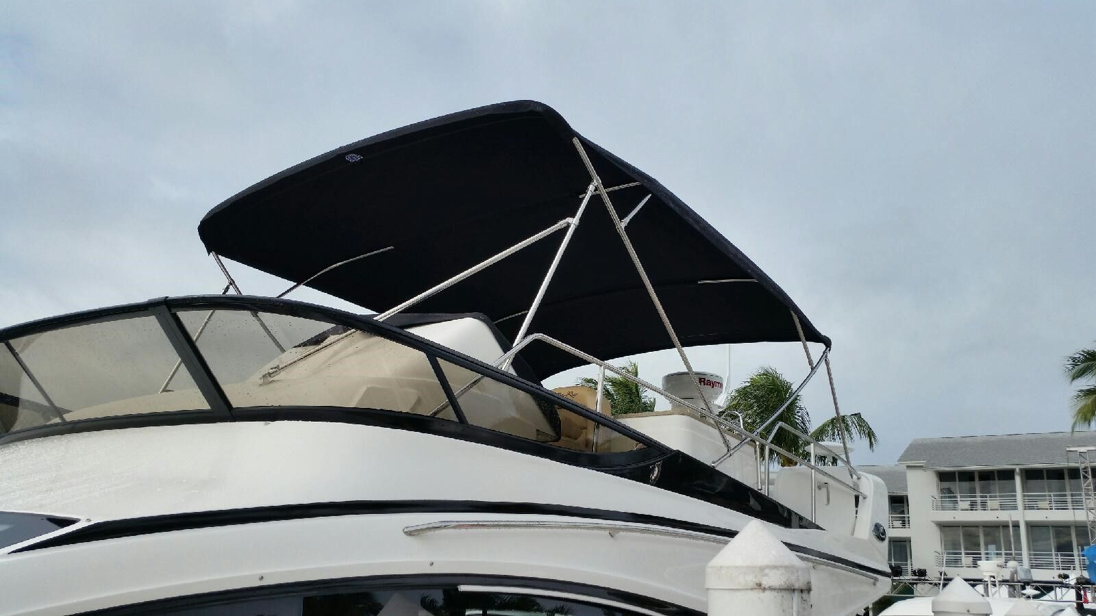 A boat with a black canopy on top of it