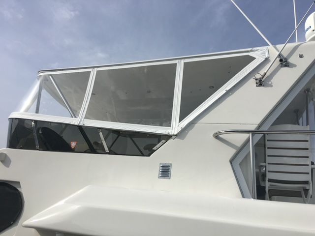 A white boat with a large window on the side