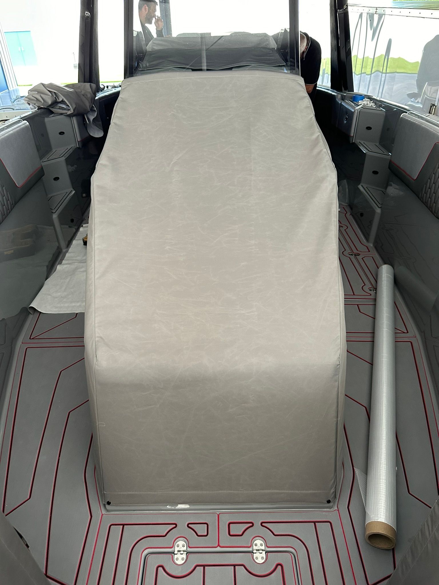 The inside of a boat with a cover on the seats