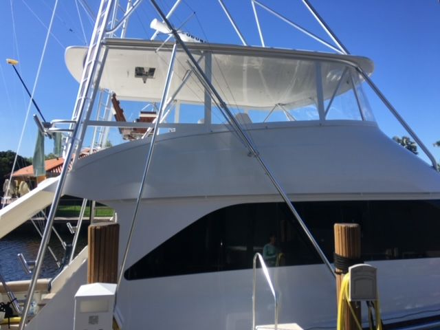 A large white boat is docked at a dock