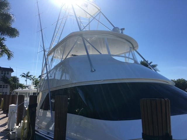 A large white boat is docked at a dock.
