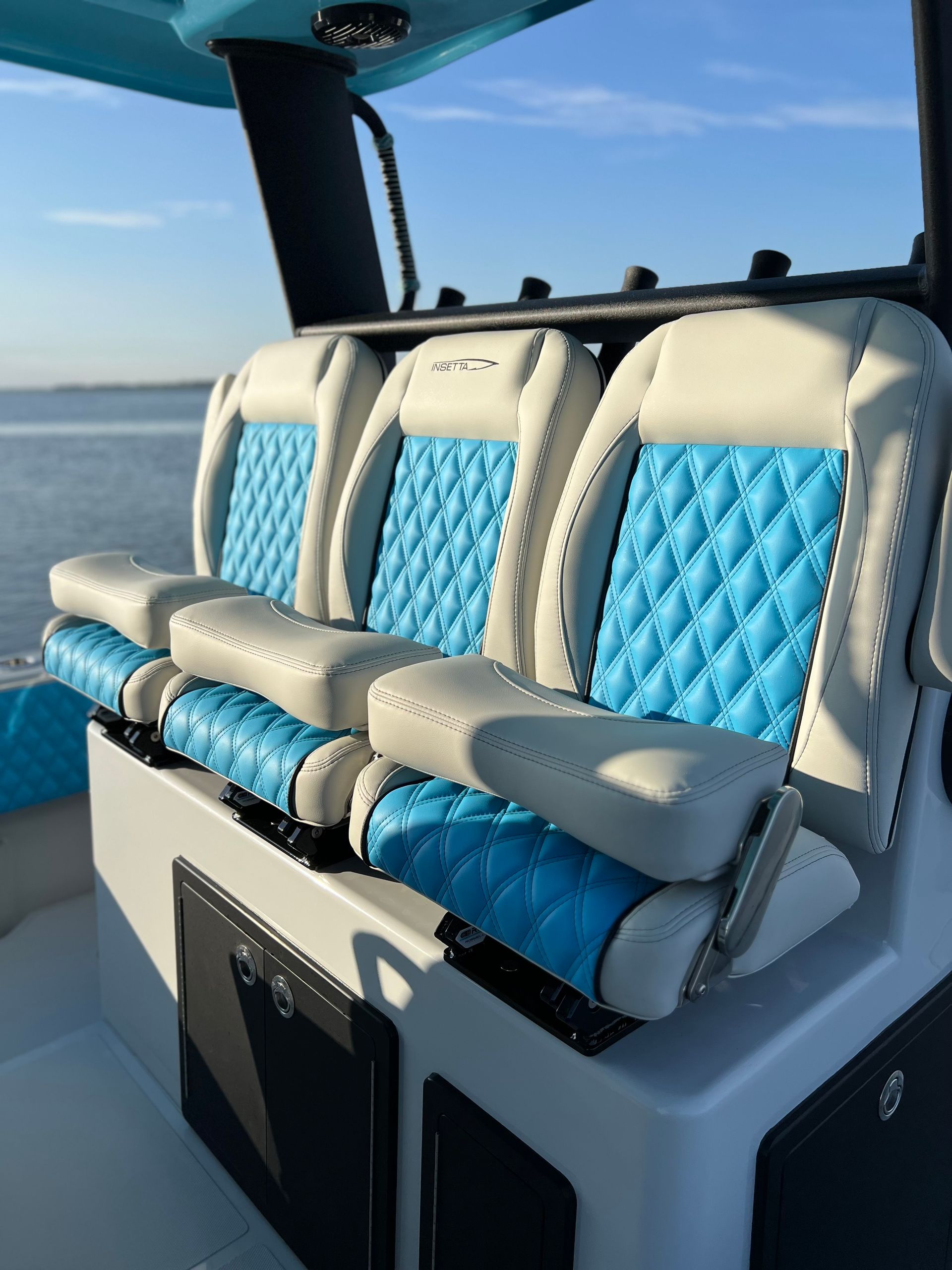 A boat with blue and white seats on the water