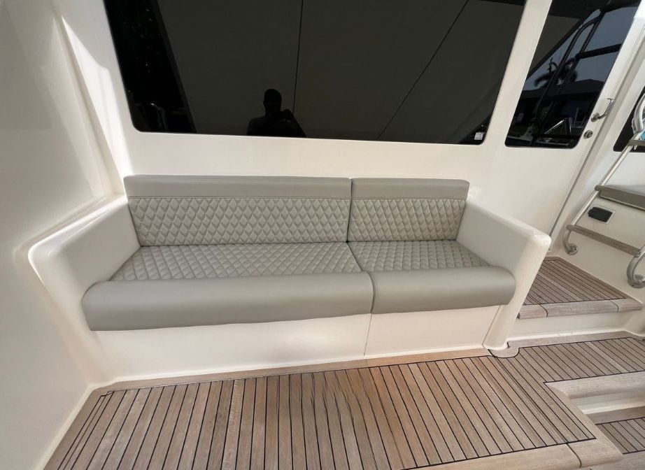 A couch on a boat with a wooden floor