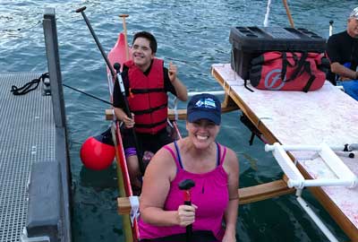 A man and a woman are sitting in a raft in the water.