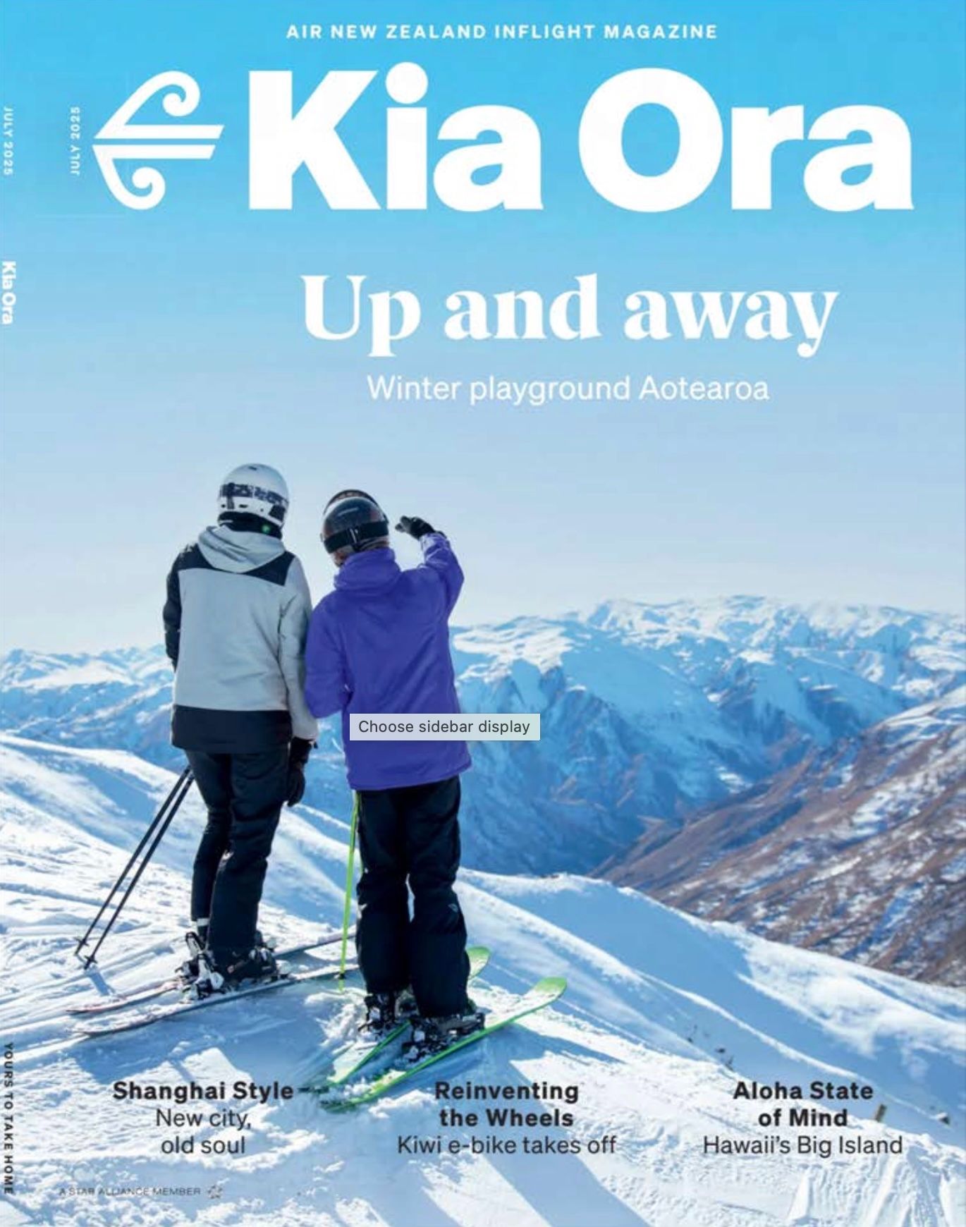 A couple of people standing on top of a snow covered mountain on the cover of a magazine.