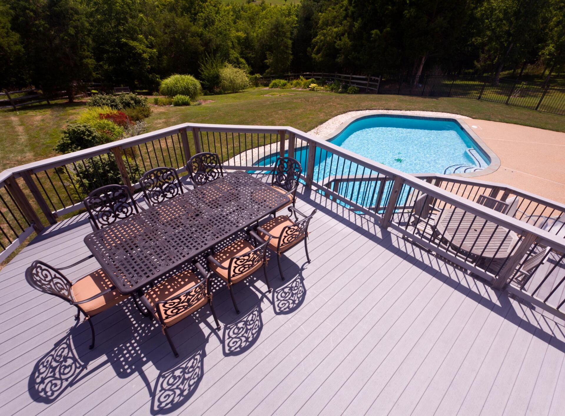 newly repaired deck with aerial view of swimming pool