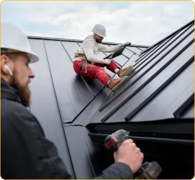 Two men are working on the roof of a building.