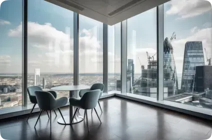 There is a table and chairs in the room with a view of the city.