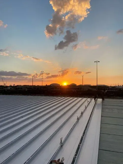 A roof with a sunset in the background