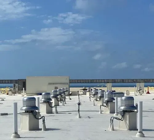 A rooftop with a lot of exhaust fans on it