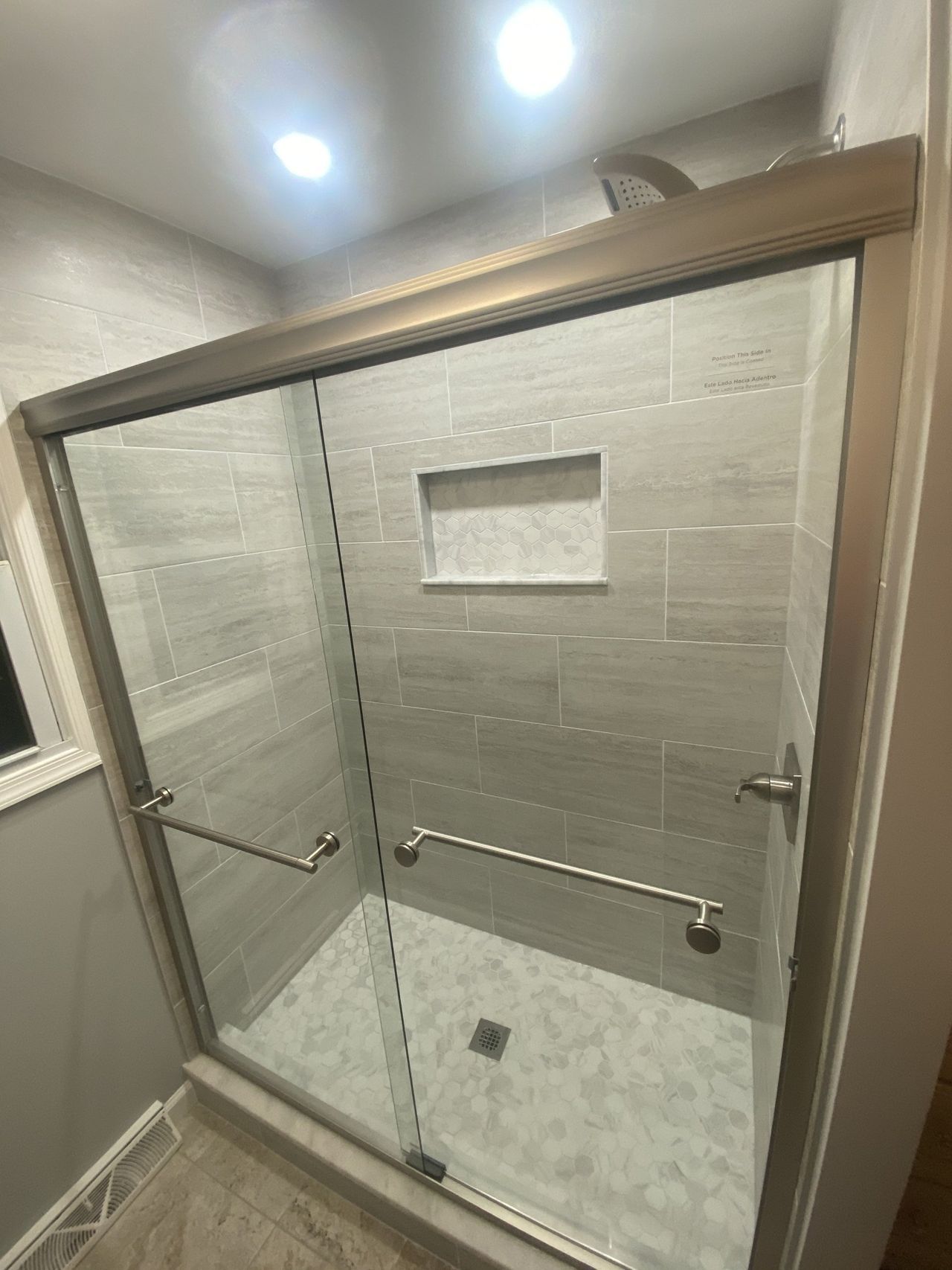 Tiled shower with sliding glass door and built-in niche – Baldwin, MD
