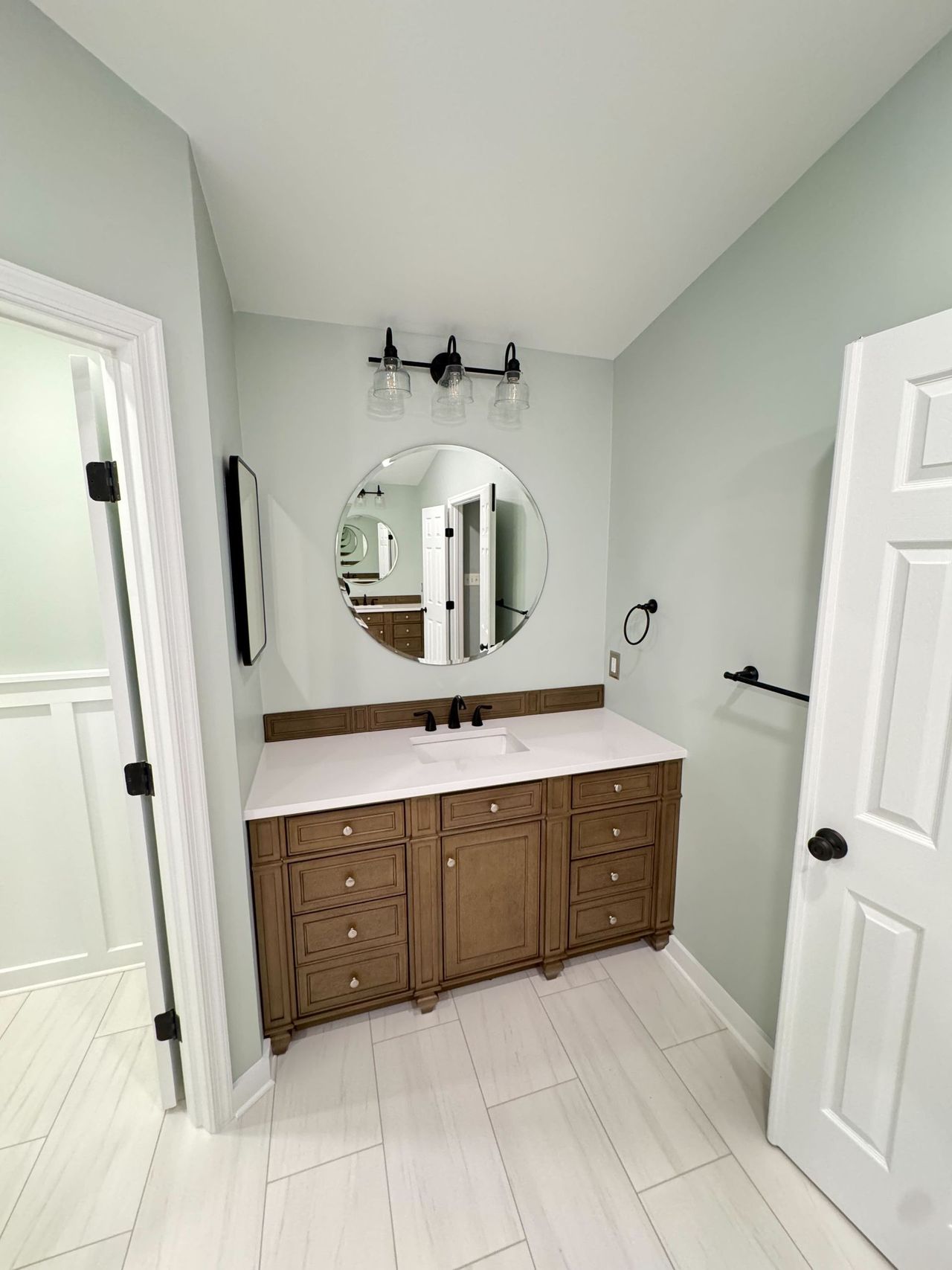New vanity with black fixtures against wainscoted walls – Arnold, MD