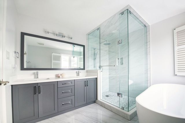 Gray shaker double vanity and glass shower