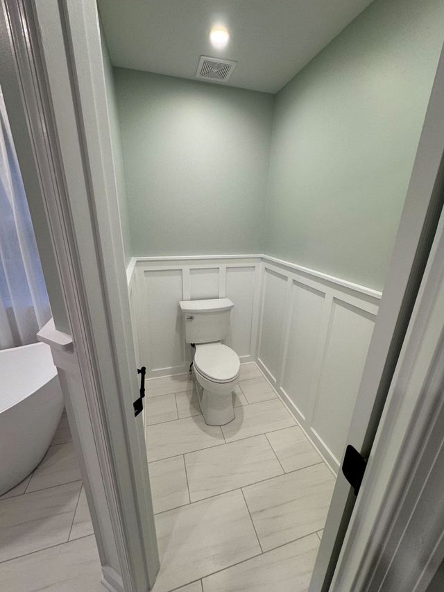 Private toilet room finished with board-and-batten wainscoting in Sykesville, MD