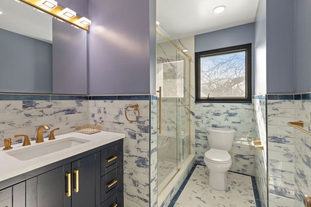 Navy vanity and glass shower remodel