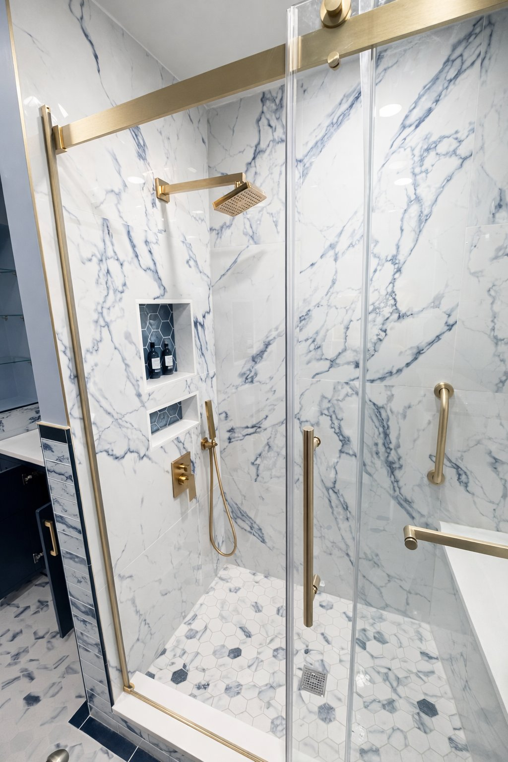 Custom bathroom renovation in Baltimore County MD featuring blue marble tile walk-in shower, brushed gold rain head, dual recessed niches, and gold sliding glass door by Handyman on Demand