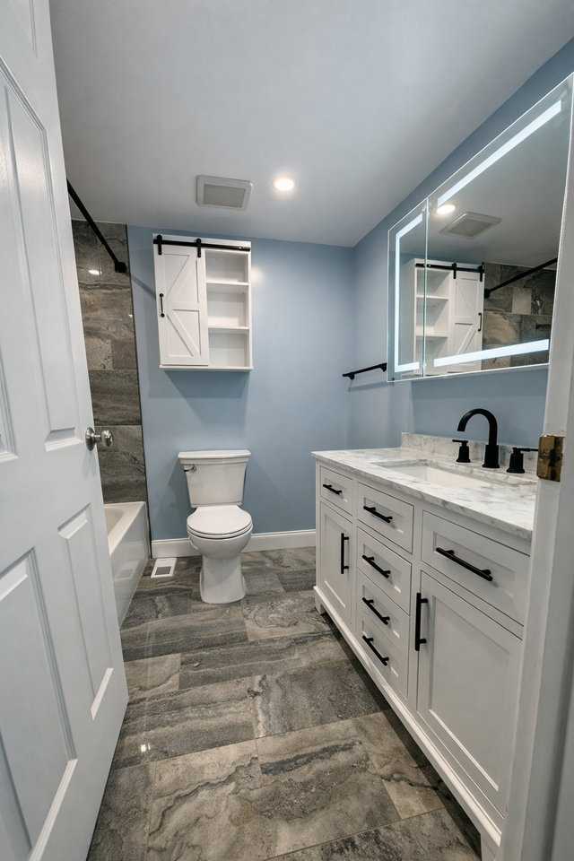 White shaker vanity, LED mirror and gray stone-look tile, a Handyman on Demand bathroom remodel
