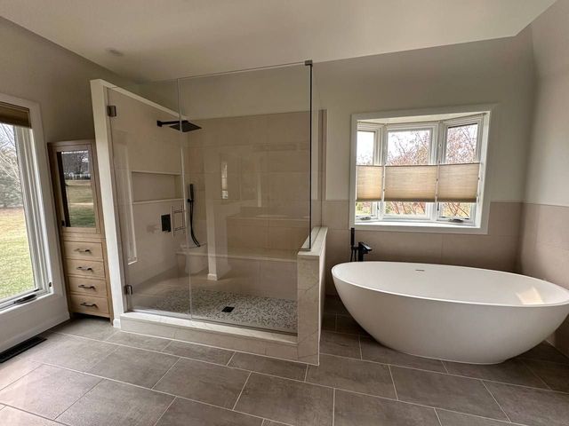 Primary bath with walk-in shower, freestanding tub and custom storage, a Handyman on Demand bathroom remodel
