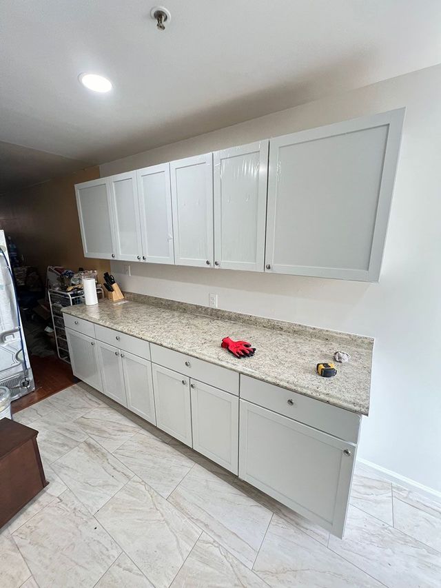 White shaker cabinets with granite counters, a Handyman on Demand kitchen remodel