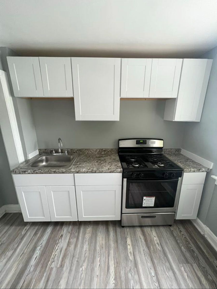 Compact kitchen with new white cabinets – Severn, MD