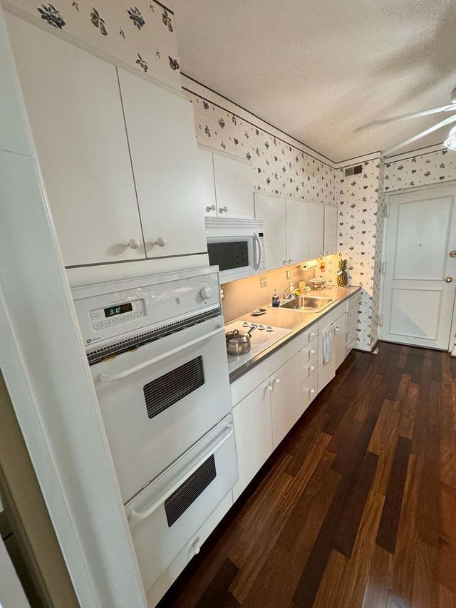 White kitchen with double wall ovens, a Handyman on Demand kitchen remodel