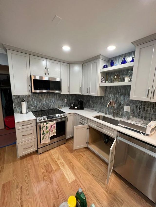 Open shelving, mosaic backsplash and gas range, a Handyman on Demand kitchen remodel
