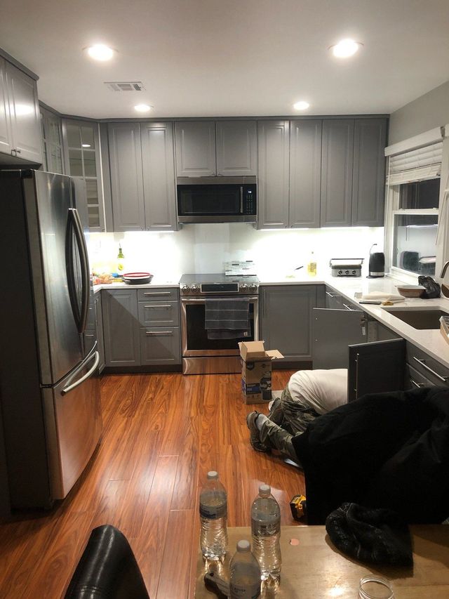 Gray cabinets, under-cabinet lights and stainless appliances, a Handyman on Demand kitchen remodel