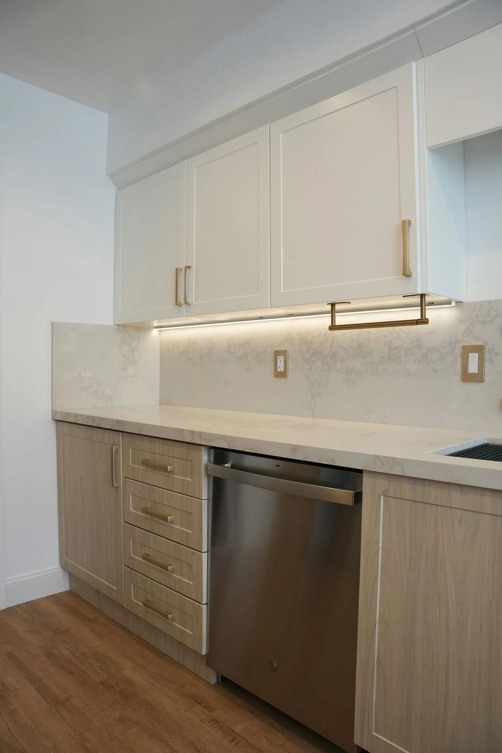 A modern kitchen features light-colored cabinets