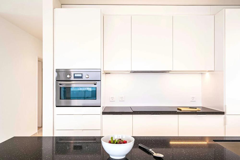 Modern white kitchen with built-in oven