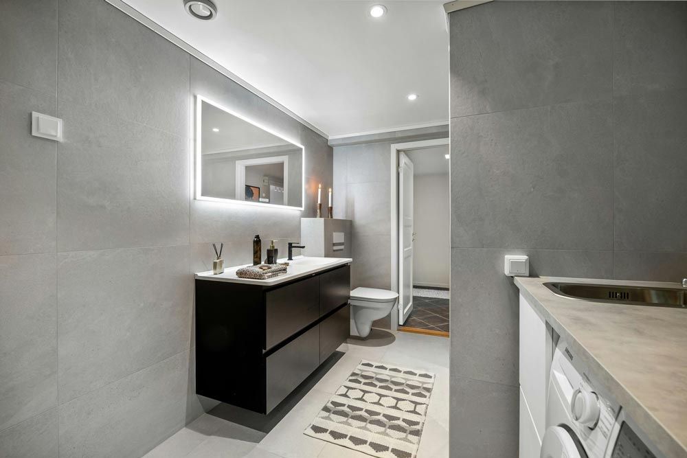 Modern bathroom with gray tile walls