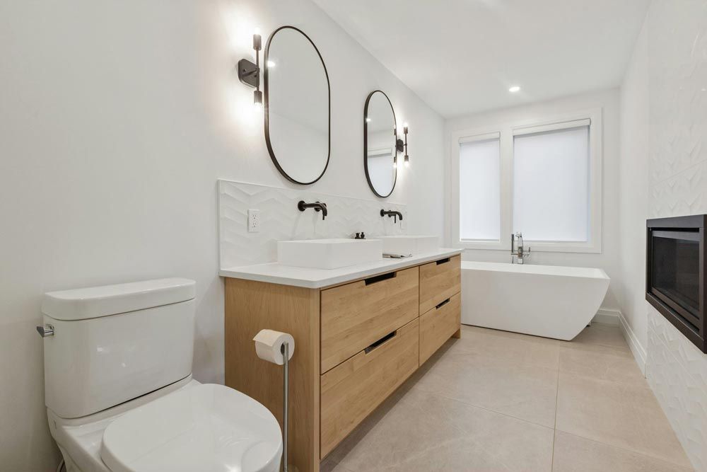 Modern bathroom with double sinks, oval mirrors