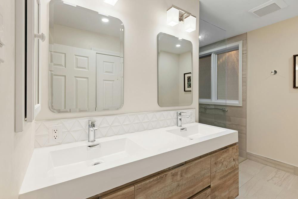 Modern bathroom with double sinks, two mirrors