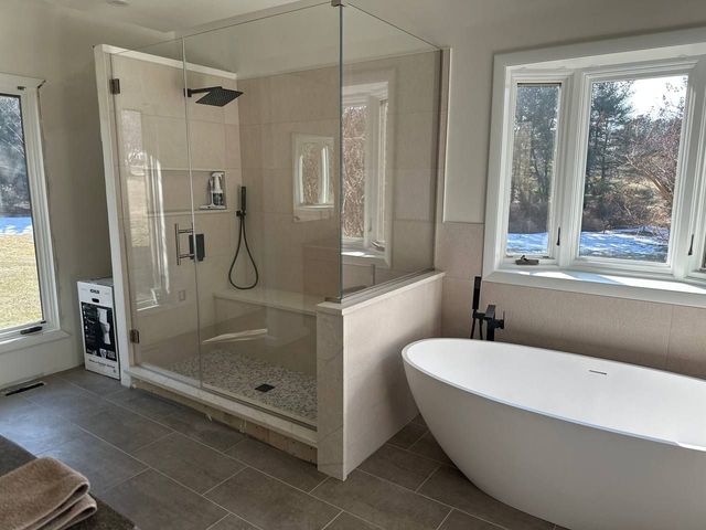Primary bathroom with glass walk-in shower and freestanding tub