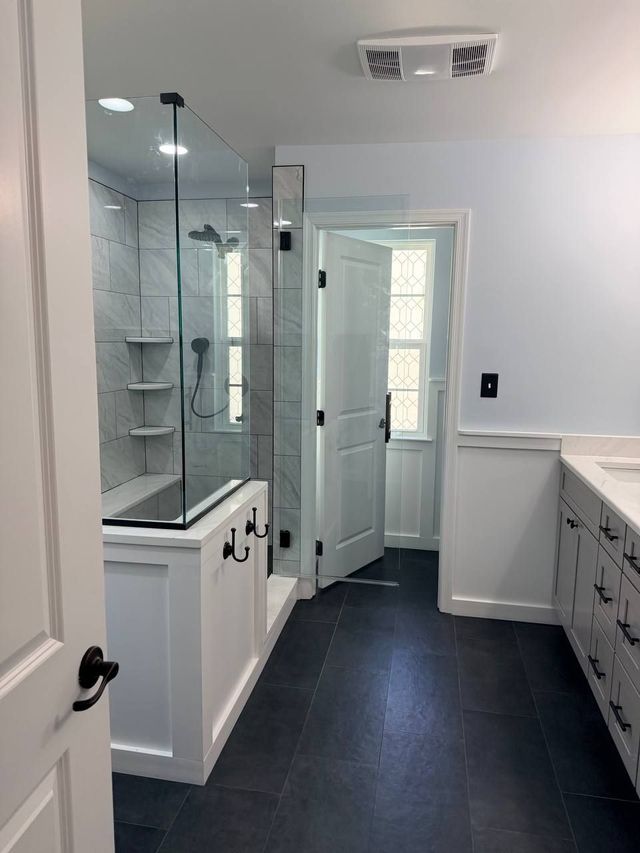 Walk-in shower, gray shaker vanity and dark slate floor, a Handyman on Demand bathroom remodel