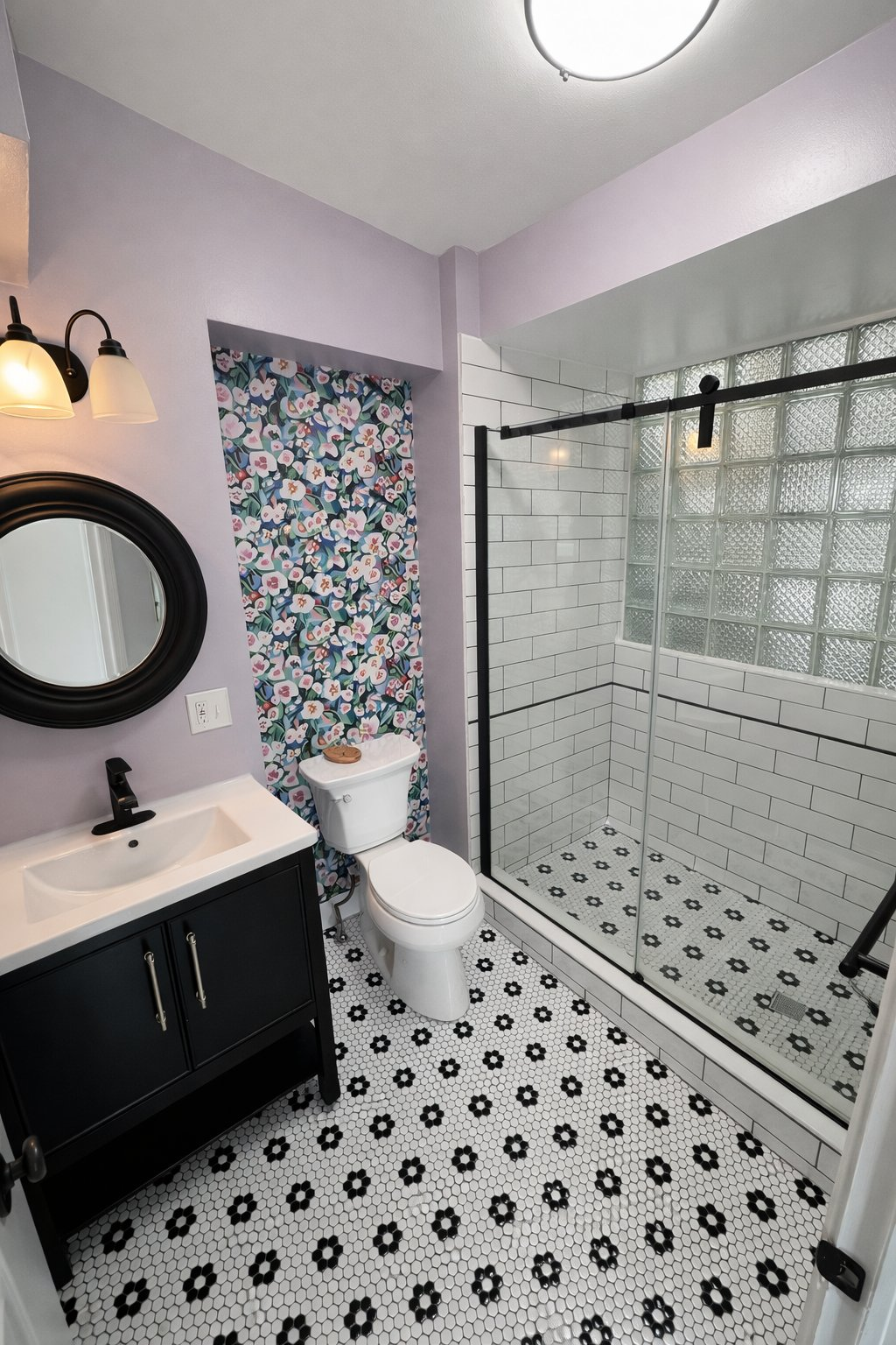 Affordable small bathroom remodel in Baltimore County MD with subway tile shower, glass block window, black and white mosaic floor tile, and black vanity by local contractor Handyman on Demand