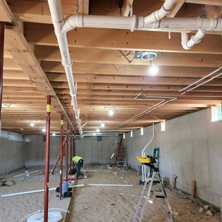 A man is working in a basement under construction.