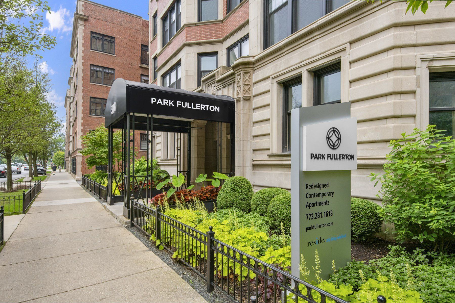 a park building with a sign in front of a sidewalk