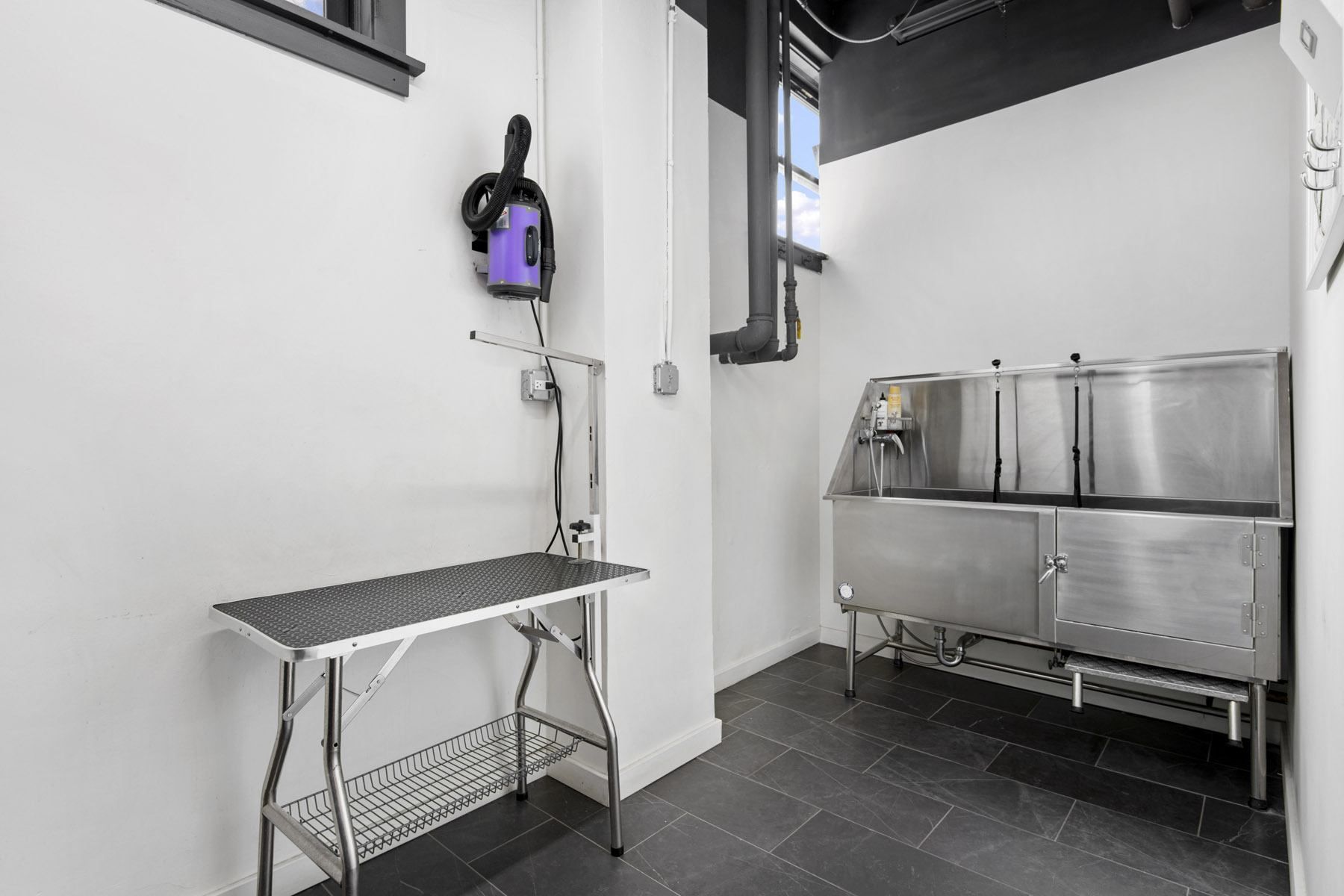 a kitchen with a sink and a metal cart