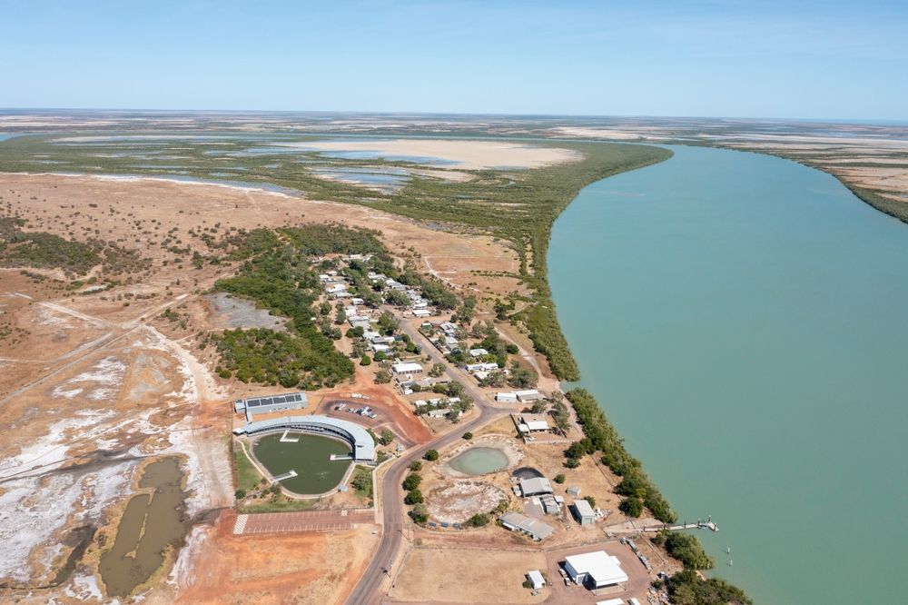 Aerial View of A Small Coastal Town Next to a Wide, Turquoise River — Active Airconz in Karumba, QLD