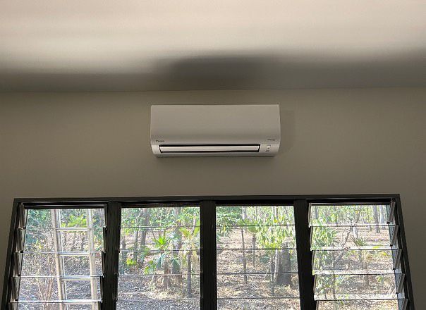 A Room With A Window And A Wall Mounted Air Conditioner — Active Airconz in Darwin, NT
