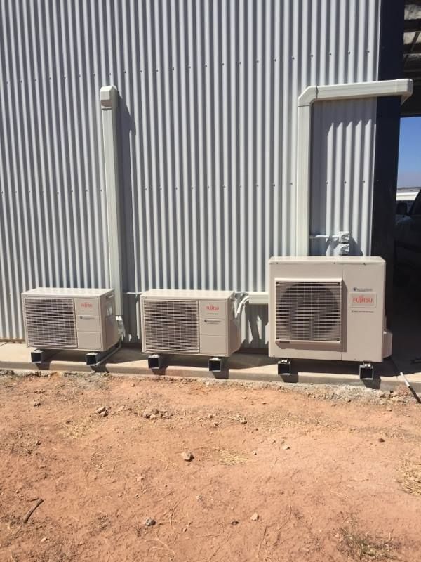 Three Air Conditioning Units Outside a Building With Corrugated Metal Siding — Active Airconz in Nhulunbuy, NT