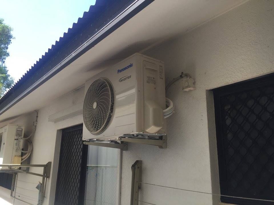 Exterior wall with a Panasonic air conditioner unit mounted below a roof. — Active Airconz in Perth, WA