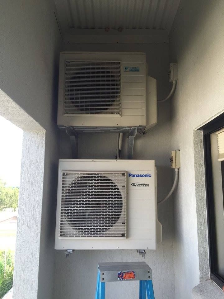 Two White Air Conditioning Units Stacked on an Exterior Wall — Active Airconz in Gold Coast, QLD