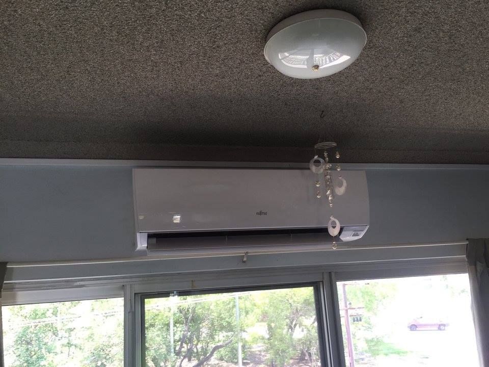Wall-Mounted Air Conditioning Unit Above a Window, Next to a Light Fixture — Active Airconz in Nhulunbuy, NT