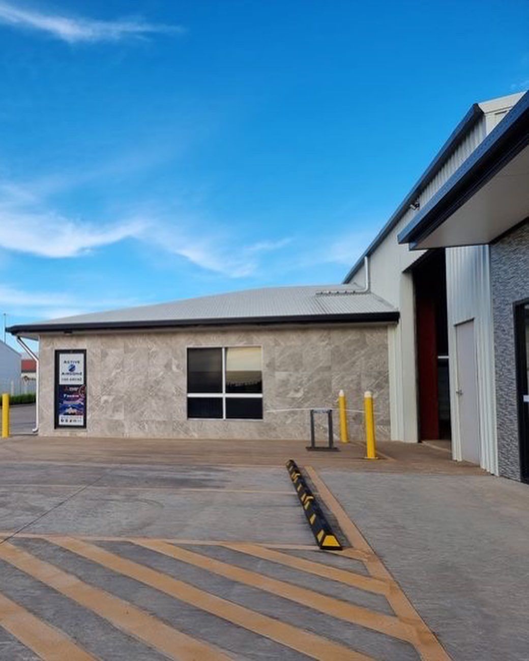 Building With Light Stone Facade and Dark Window, Blue Sky — Active Airconz in Katherine, NT
